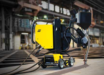 Yellow and black Versotrac welding tractor parked on the ground.