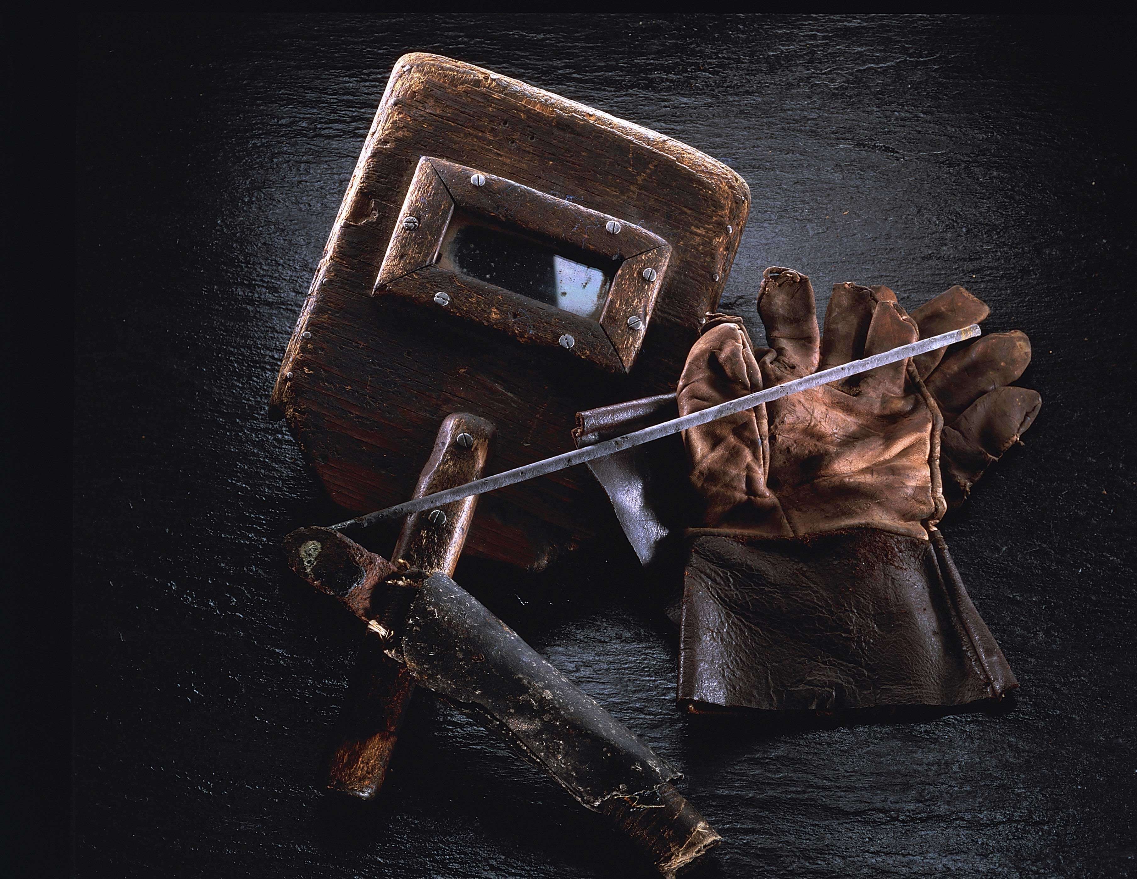 Historical welding helmet and gloves